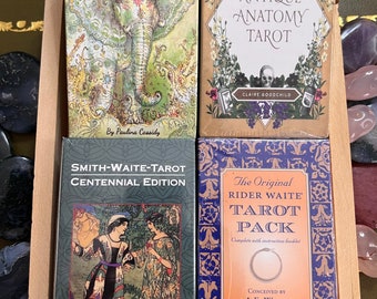 May include: Four different tarot card decks, including the SpiritSong Tarot, The Antique Anatomy Tarot, the Smith-Waite Tarot Centennial Edition, and The Original Rider Waite Tarot Pack.