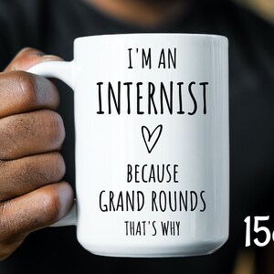 May include: White ceramic mug with black text that reads "I'm an Internist because Grand Rounds That's Why" with a heart symbol. The mug is 15 ounces.
