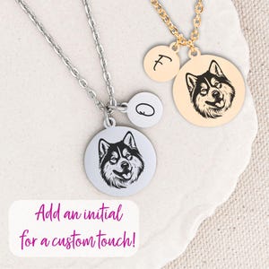 May include: Two silver necklaces with round pendants. One pendant features a black and white husky silhouette, the other has a single letter 'O'. A second necklace with a gold chain has a round pendant with a black and white husky silhouette and a round pendant with the letter 'F'. The text 'Add an initial for a custom touch!' is displayed below the necklaces.