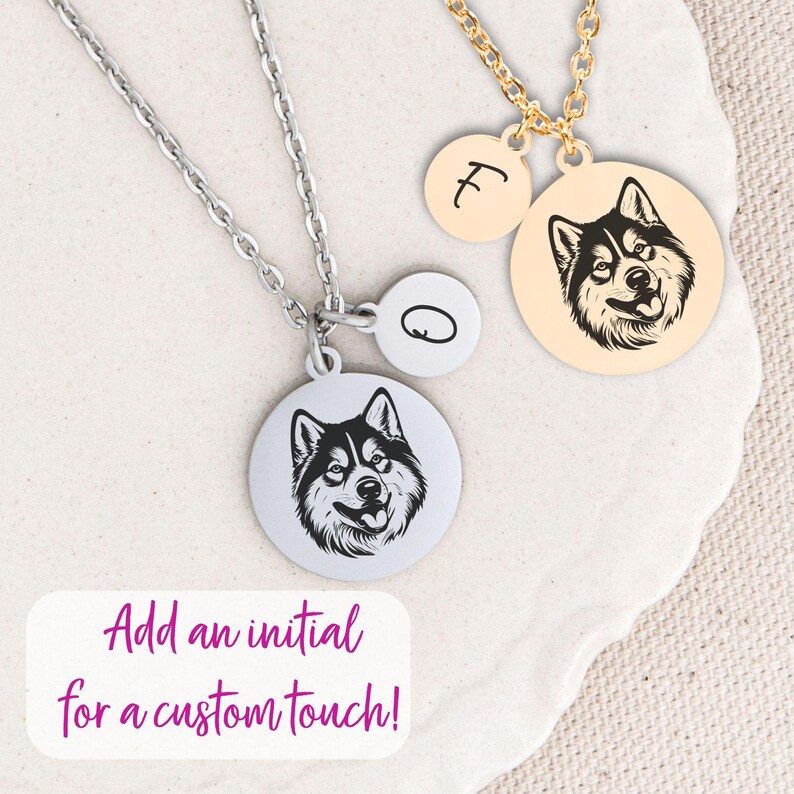 May include: Two silver necklaces with round pendants. One pendant features a black and white husky silhouette, the other has a single letter 'O'. A second necklace with a gold chain has a round pendant with a black and white husky silhouette and a round pendant with the letter 'F'. The text 'Add an initial for a custom touch!' is displayed below the necklaces.