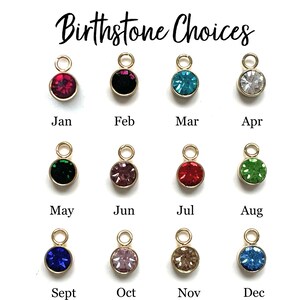 May include: Birthstone Choices: A chart showing 12 different colored gemstones, each representing a different month of the year.  The gemstones are arranged in three rows of four, with the month name written below each gemstone.  The gemstones are: January - Garnet (red), February - Amethyst (purple), March - Aquamarine (blue), April - Diamond (clear), May - Emerald (green), June - Alexandrite (pink), July - Ruby (red), August - Peridot (green), September - Sapphire (blue), October - Opal (pink), November - Topaz (brown), December - Tanzanite (blue).