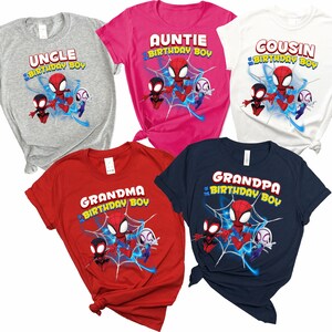 May include: Set of six t-shirts featuring a cartoon Spider-Man design. Each shirt has a different text, including "Uncle", "Auntie", "Cousin", "Grandma", "Grandpa", and "Birthday Boy".