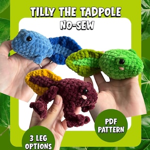 May include: Image of four crocheted tadpoles in blue, green, and burgundy with yellow accents. The text "Tilly the Tadpole No-Sew" is at the top, with "3 Leg Options" and "PDF Pattern" at the bottom. The tadpoles are held in hands.