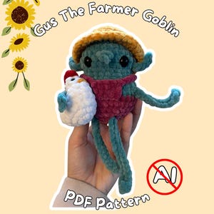 May include: A teal crochet goblin doll wearing a mustard yellow hat and maroon overalls, holding a small white chicken with a red comb. The text reads Gus The Farmer Goblin and PDF Pattern, with a red circle and slash over the letters AI.