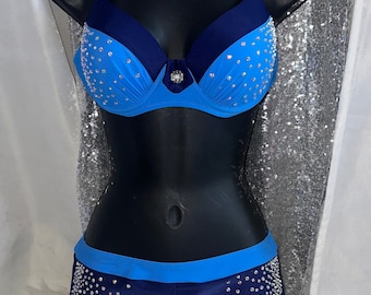 May include: A blue and navy bikini with crystal embellishments. The top has a push-up style and the bottoms are high-waisted.