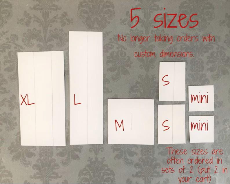 May include: Seven white rectangular paper cards arranged in a display, labeled with red text as XL, L, M, S, and mini sizes. The image includes red text stating 5 sizes, No longer taking orders with custom dimensions, and These sizes are often ordered in sets of 2.