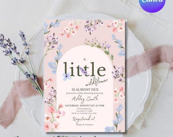 May include: A baby shower invitation with a floral design. The invitation features the text "A little wildflower" and event details. The design includes pink, purple, and blue flowers, with the words "Instant Download" at the bottom.