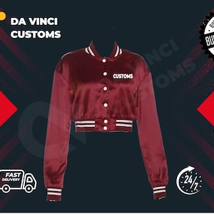 May include: A red satin bomber jacket with white ribbed trim and a white "CUSTOMS" embroidered on the front. The jacket is cropped and has a button closure.