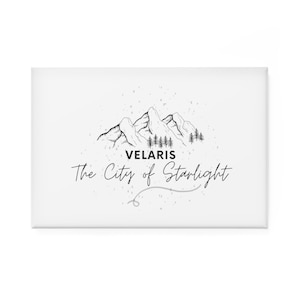 May include: Black and white illustration of a mountain range with trees, with the text "VELARIS The City of Starlight" below.