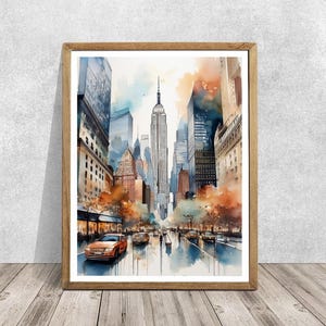 Puede incluir: Pintura acuarela de una escena de calle de la ciudad con edificios altos, incluido el Empire State Building, y un taxi amarillo conduciendo por la calle. La pintura tiene una sensación suave y de ensueño con una lavada de acuarela naranja y azul.