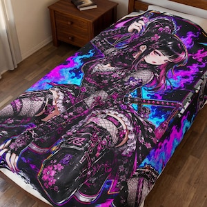 May include: A rectangular blanket featuring a vibrant anime-style illustration of a character with dark hair and pink highlights, dressed in black tactical gear with fishnet accents, surrounded by bright blue and purple flames and pink cherry blossoms.
