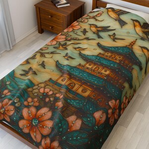 May include: A decorative bedspread featuring a detailed illustration of a pagoda with a teal roof, surrounded by birds and flowers in shades of orange, teal, and brown. The design has a vintage, artistic style.