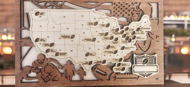 May include: A wooden map of the United States with a football design. The map shows the locations of all 32 NFL teams. The map is surrounded by a wooden frame and has a small wooden plaque with the NFL logo.