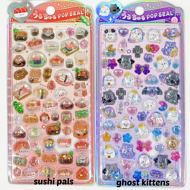 Puede incluir: Dos hojas de pegatinas con pegatinas transparentes y brillantes. Una hoja presenta dise&ntilde;os de sushi y gatos con el texto "sushi pals". La otra hoja tiene dise&ntilde;os de fantasmas y gatitos con el texto "ghost kittens". Ambas tienen el texto "うるちゅる POP SEAL."