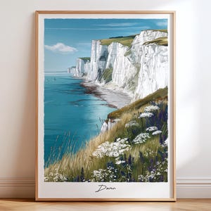 May include: A framed print featuring the White Cliffs of Dover. The artwork shows the white chalk cliffs, the blue sea, and sky, with green grass and white wildflowers in the foreground. The word "Dover" is written at the bottom of the print.