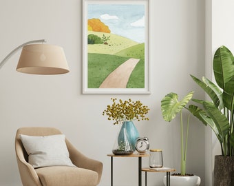 May include: A watercolor painting of a path winding through a green grassy field with a small yellow tree in the background. The painting is framed in a white frame and hanging on a white wall.