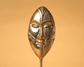 Brass figure "Face"