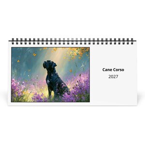 Puede incluir: Un calendario de pared con encuadernación en espiral que muestra un perro Cane Corso negro sentado en un campo de flores moradas con mariposas naranjas bajo una luz suave. El texto a la derecha dice Cane Corso 2027 en letras negras.