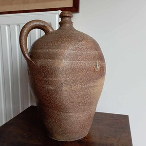 Old antique French vintage jug, bottle, or carafe made of stoneware, earthenware, or stoneware. Unique piece!
