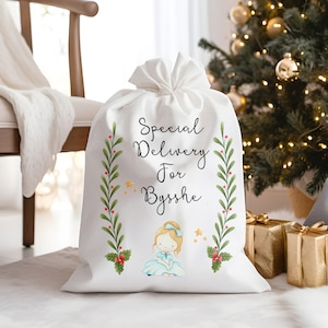 May include: White Christmas gift bag with a green and red holly design, a little girl illustration, and the text "Special Delivery for Bysshe".