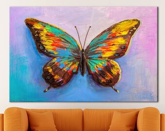May include: A colorful painting of a butterfly with brown, yellow, blue, green, and red wings. The butterfly is painted on a light blue background with a purple gradient.