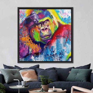 May include: A colorful abstract painting of a gorilla's face with graffiti-style text and drips of paint in shades of blue, yellow, green, red, and pink.