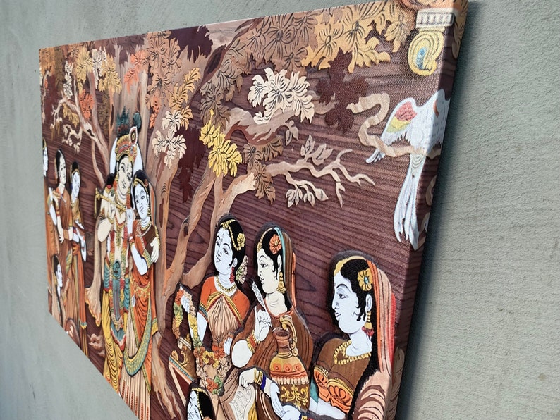 May include: A wood carving depicting a scene from Hindu mythology. The carving features multiple figures, including Krishna and Radha, surrounded by trees and birds. The carving is painted in vibrant colours, including red, yellow, green, and blue.