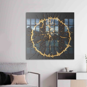 May include: Abstract art print featuring a gold circle with a cracked, textured design on a black background.