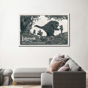 May include: A black and white illustration of a scene from the film Labyrinth. A large, furry creature with a long snout is reaching out to a young girl. The creature is surrounded by trees and other foliage. The text "Labyrinth" is printed in a stylised font at the bottom of the image.