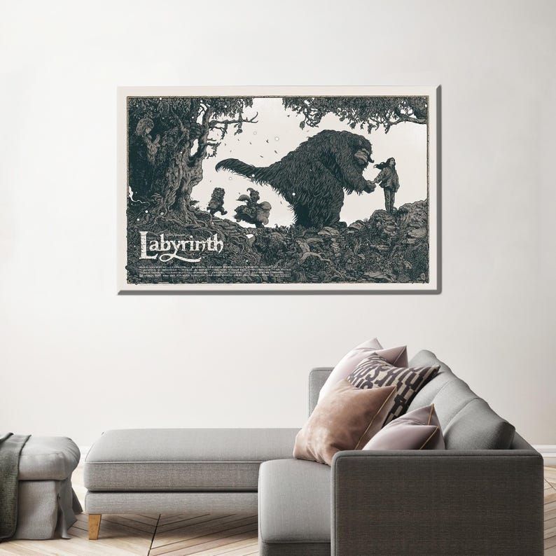 May include: A black and white illustration of a scene from the film Labyrinth. A large, furry creature with a long snout is reaching out to a young girl. The creature is surrounded by trees and other foliage. The text "Labyrinth" is printed in a stylised font at the bottom of the image.