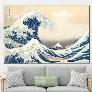 May include: A woodblock print of a large wave crashing over three boats with Mount Fuji in the background. The wave is blue and white with splashes of foam. The boats are small and wooden. The mountain is snow-capped and in the distance. The print is titled "神奈川沖浪裏" in Japanese.
