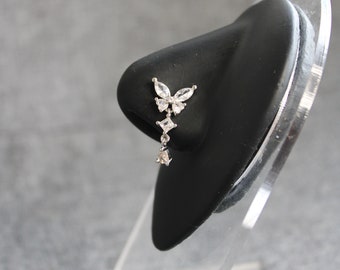 May include: A silver nose ring with a butterfly design and dangling clear crystals.