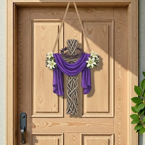 May include: A decorative wooden cross with a woven design, adorned with a purple drape, a crown of thorns, and white lilies. The cross hangs from a rope on a wooden door, creating a religious or Easter-themed decoration.