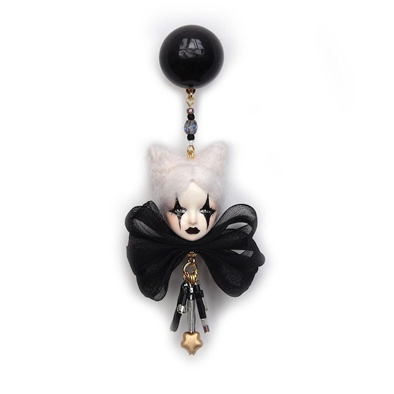 Dark Harlequin doll earrings hand-sculpted into tiny creepy-cute art — 279 favorites confirms this is a genuine cult hit.