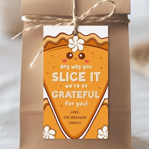 Puede incluir: Una etiqueta de regalo naranja con un diseño de rebanada de pastel. La etiqueta tiene detalles en blanco y marrón y el texto "any way you slice it, we're so grateful for you!" y "Love, The Brenner Family."