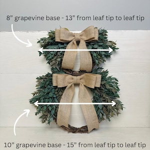May include: Two grapevine wreaths with burlap bows. The smaller wreath is 8 inches in diameter and 13 inches wide. The larger wreath is 10 inches in diameter and 15 inches wide.
