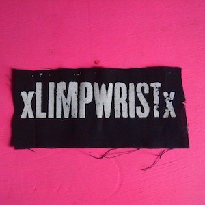 May include: Black fabric patch with white text that reads "XLIMPWRISTX".