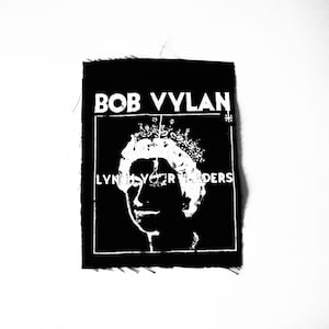 May include: Black patch with white text and a graphic of a person wearing a crown. The text reads "BOB VYLAN" at the top and "LYNCH YOUR LEADERS" below the graphic.
