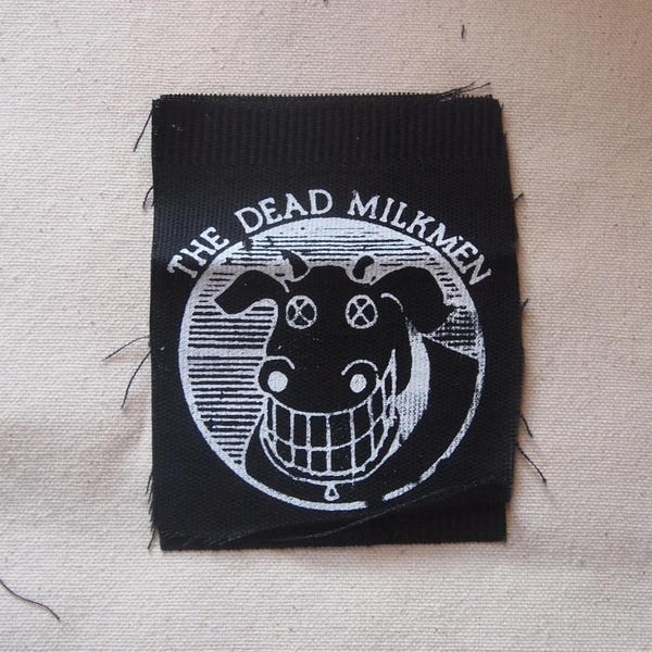 Parche con el logotipo de Dead Milkmen