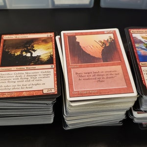 May include: A stack of red Magic: The Gathering cards, including "Heat Ray", "Goblin Skycutter", "Fury", and "Reckless Air Sabre".