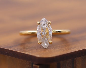 May include: A gold ring with a marquise-shaped diamond.