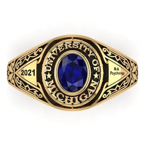 Peut inclure: Une bague de classe en or avec une pierre bleue et l'inscription "University of Michigan" et "B.A. Psychology". L'année "2021" est gravée sur le côté de la bague.