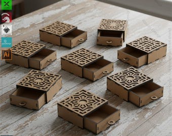 May include: Several small, open wooden boxes with decorative, geometric cut-out lids and pull-out drawers are arranged on a light-colored surface. The boxes are labeled "4-DESIGNS BOX WITH DRAWERS" and include file type information.