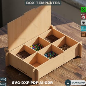 May include: A light-colored wooden box with six compartments, filled with beads and small objects. The box has a hinged lid and is labeled "BOX TEMPLATES" and "SVG-DXF-PDF-AI-CDR". The box is 1/8 inch (3mm) thick.