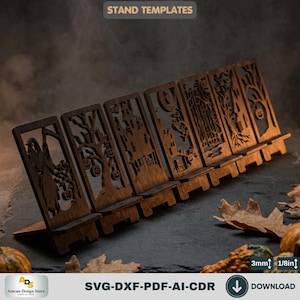 May include: A set of six dark brown laser-cut wooden phone stands featuring intricate Halloween-themed silhouettes including a grim reaper, haunted houses, and trees with pumpkins. The text STAND TEMPLATES is visible. Material thickness is 1/8 inch.