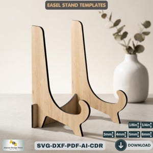 May include: Two wooden easel stands with black trim. The stands are made of light-colored wood and have a curved design. Text at the top reads "EASEL STAND TEMPLATES". The bottom of the image includes text that reads "SVG-DXF-PDF-AI-CDR" and measurement labels for 1/8in, 1/4in, 3mm, 4mm, 5mm, and 6mm.