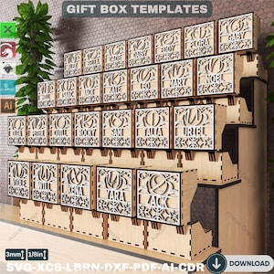 May include: Wooden gift box templates with laser-cut designs. Each box features a name, such as "Alex," "Bella," and "Cade," in an elegant font. The boxes are arranged on a tiered display, with the text "GIFT BOX TEMPLATES" at the top.