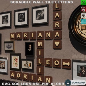 May include: A wall decor set featuring wooden Scrabble tiles spelling out the names "Mariana", "Leo", and "Adrian". The tiles are arranged in a crossword pattern with a heart-shaped tile in the center. The names are surrounded by framed pictures and a clock.