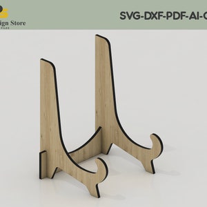 May include: A wooden easel stand with a natural wood finish and black edges. The stand is designed to hold a plate or other flat object.