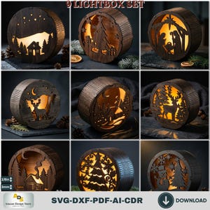 May include: A 9 LIGHTBOX SET featuring circular dark wood frames with intricate laser-cut holiday scenes including a nativity, reindeer, snowmen, and winter landscapes. Each piece is illuminated from within, casting a warm glow through the cutouts.